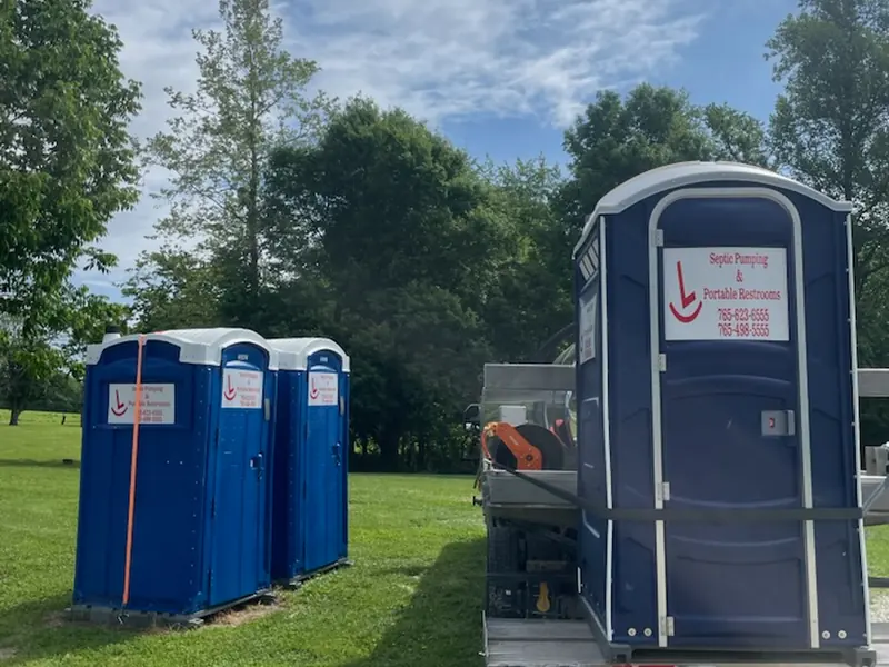 Portable restrooms being unloaded from a Rockin L trailer at a work site in west-central Indiana